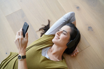 Woman listening to music with bluetooth headset
