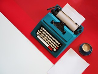 Top view vintage Typewriter on red background,copy space.