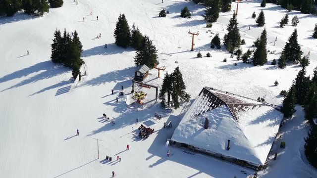 Birds eye view of Snezhanka Peak from the Tv tower balcony. Sunniest modern Bulgarian ski resort, located close to Smolyan Town, heart of Rhodopi Mountain. 4K down angle