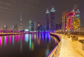 Dubai - The nightly skyline over the Canal and Downtown with the waterfall on the bridge.
