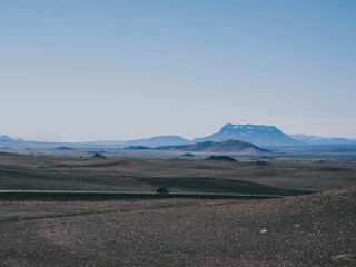one car on road with black sand and mountains around, Iceland © LIGHTFIELD STUDIOS