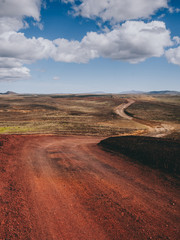 landscape with road with red volcanic sand in Iceland