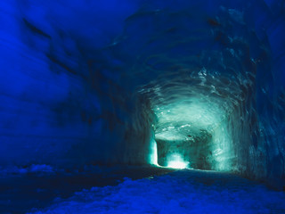 Tunnel with light inside ice cave in the Langjokull glacier in Iceland