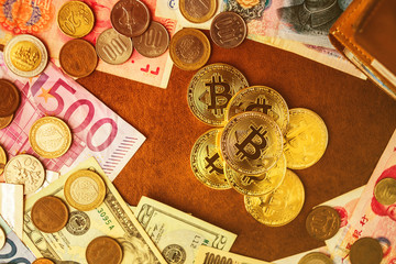 golden bitcoin coin on internation mpny bill with wallet on brown leather background business ideads concept