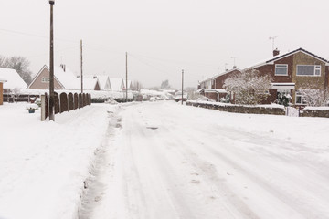 Heavy snowfall on a housing estate in the United Kingdom  with roads blocked by snow and ice