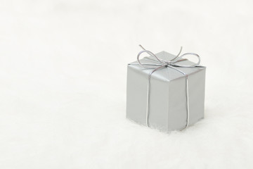 Silver gift box on a white background, copy space. Holiday concept