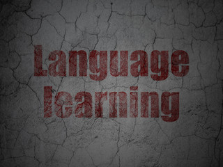 Education concept: Red Language Learning on grunge textured concrete wall background