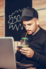 Happy young man using smart phone