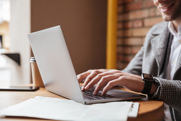 Cropped image of smiling business man sitting by the table