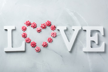 Valentines day holiday text word love with pink meringue heart