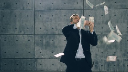 Man in formal suit dancing and throwing money. Slow motion - Powered by Adobe
