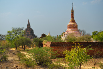 Pink stupa of Buddhist ancient temple in small village in area of Bagan, Myanmar (Burma).