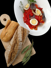 tray with peppers salad and kitchen board with bread