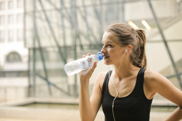 Fit girl drinking water