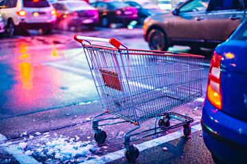 Supermarket cart on night car parking