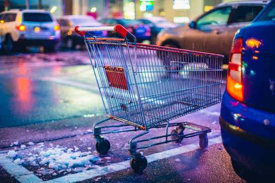 Supermarket cart on night car parking