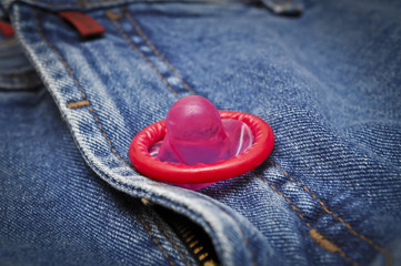 Red condom in jeans 