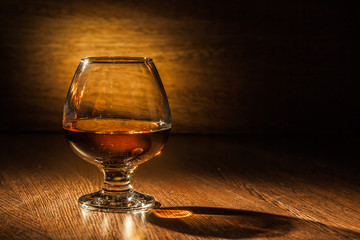 Cognac drinks glass on dark background