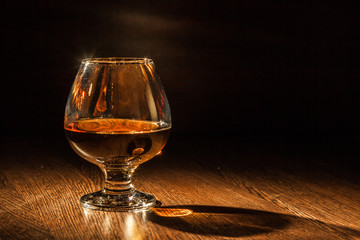 Cognac drinks glass on dark background