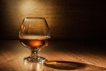 Cognac drinks glass on dark background