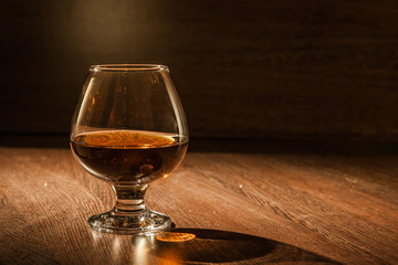 Cognac drinks glass on dark background