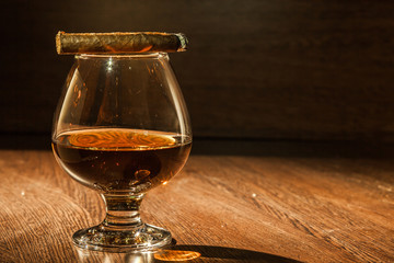 Cognac drinks glass on dark background