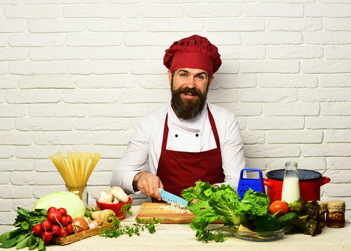 Chef chopping vegetables on a wooden cutting board