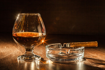 Cognac drinks glass on dark background