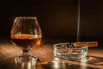 Cognac drinks glass on dark background