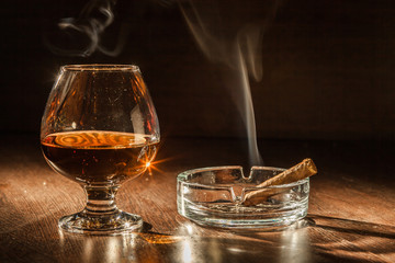 Cognac drinks glass on dark background