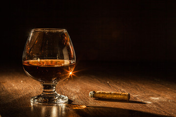 Cognac drinks glass on dark background