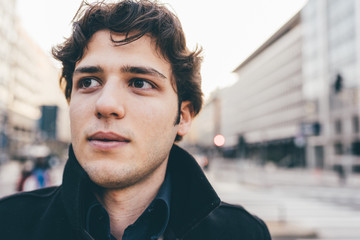 young man outdoor looking away pensive - serious, thinking concept