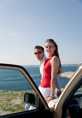 Couple with oldtimer by sea
