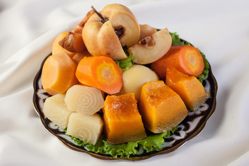 Cold vegetables.Pumpkin, carrots, turnips, quince on the plate.The upper projection.
