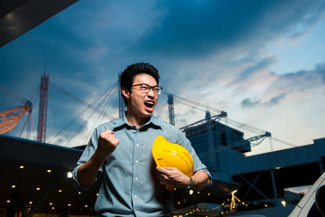 Asian welcome smile Engineering manager, field engineer, foreman celebrate after construction site project complete on time. Business teamwork success concept on city background
