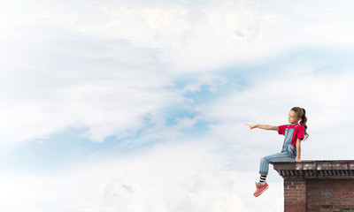 Concept of careless happy childhood with girl showing touch gesture