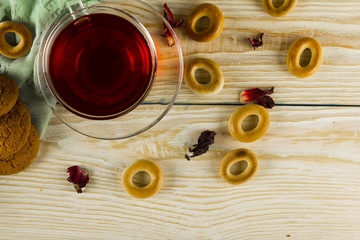 Cup of tea and leaves tea on white wooden table