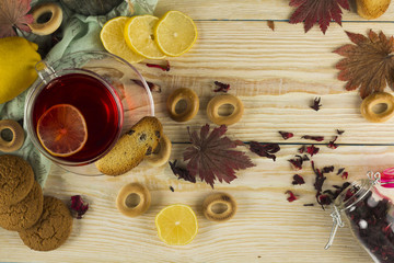 Cup of tea and leaves tea on white wooden table