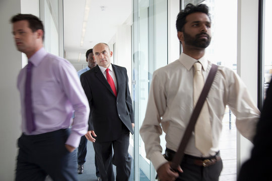 Business People Walking Fast Past Camera