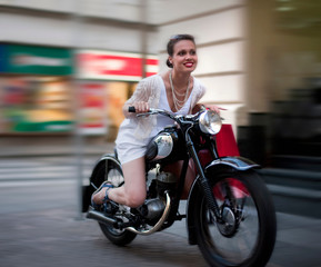 Naklejka na ściany i meble Young woman riding motorcycle