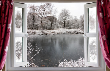 Beautiful frozen lake scene through an open window