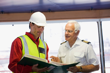 Captain of a ship discussing with a work