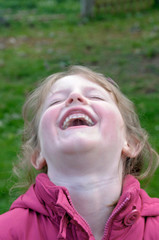 Close up of girl laughing in backyard