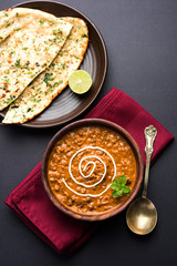 Dal makhani or dal makhni is a popular food from Punjab / India made using  whole black lentil, red kidney beans, butter and cream and served with garlic naan or Indian bread or roti     © StockImageFactory