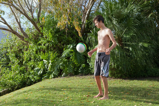 Teenage boy playing with soccer ball