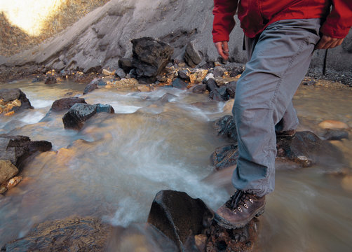 Hiker Crossing Rocky River