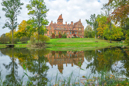 Old red castle with orange roof at Latvia.