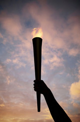 Hand holding flaming baton © Image Source RF