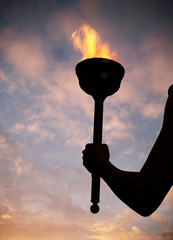 Hand holding flaming baton © Image Source RF