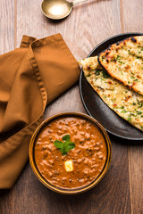 Dal makhani or dal makhni is a popular food from Punjab / India made using  whole black lentil, red kidney beans, butter and cream and served with garlic naan or Indian bread or roti     © StockImageFactory